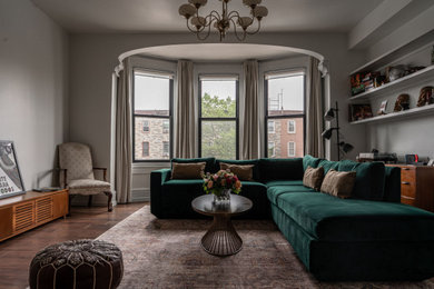 Inspiration for a transitional vinyl floor and brown floor living room remodel in Philadelphia with white walls and a wood fireplace surround