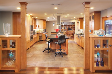 Eat-in kitchen - large contemporary u-shaped eat-in kitchen idea in Sacramento with recessed-panel cabinets, white cabinets, wood countertops, white backsplash, ceramic backsplash and an island