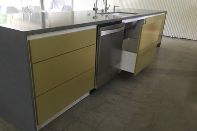 Kitchen - contemporary concrete floor kitchen idea in Sacramento with a double-bowl sink, flat-panel cabinets, stainless steel appliances and an island