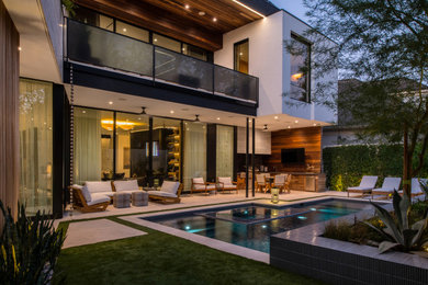 Inspiration for a small modern concrete paver pool landscaping remodel in Houston