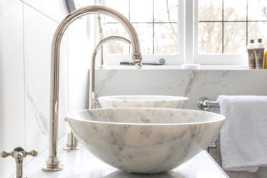 Bathroom - mid-sized transitional kids' white tile and porcelain tile porcelain tile, white floor, double-sink and coffered ceiling bathroom idea in Surrey with shaker cabinets, blue cabinets, a wall-mount toilet, white walls, a vessel sink, marble countertops, white countertops and a freestanding vanity