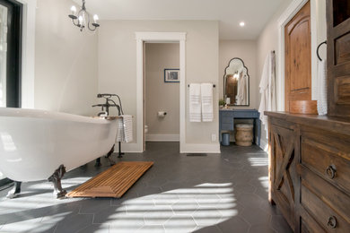 Country wet room bathroom in San Francisco with furniture-like cabinets, distressed cabinets, a claw-foot tub, white tile, ceramic tile, ceramic floors, a vessel sink, wood benchtops, black floor, a hinged shower door, a shower seat, a double vanity and a freestanding vanity.