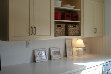 Example of a mid-sized classic single-wall porcelain tile and brown floor dedicated laundry room design in Philadelphia with an undermount sink, shaker cabinets, white walls and a side-by-side washer/dryer