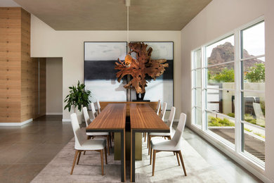 Large contemporary kitchen/dining combo in Phoenix with white walls, limestone floors and beige floor.