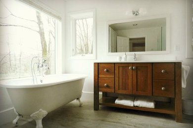 Large farmhouse master white tile vinyl floor and gray floor bathroom photo in New York with shaker cabinets, medium tone wood cabinets, a two-piece toilet, white walls, an integrated sink, solid surface countertops and a hinged shower door