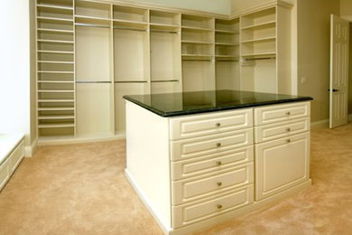 Storage and wardrobe in Orlando with white cabinets and carpet.