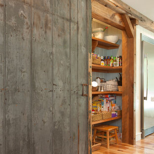 Design ideas for a large eclectic u-shaped kitchen pantry in Manchester with a farmhouse sink, flat-panel cabinets, grey cabinets, granite benchtops, stainless steel appliances, light hardwood floors and multiple islands.