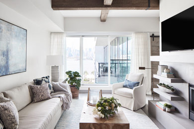 Inspiration for a transitional open concept dark wood floor and brown floor living room remodel in New York with white walls, a standard fireplace and a wall-mounted tv