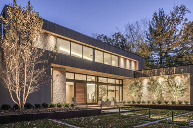 Large contemporary beige two-story mixed siding flat roof idea in New York