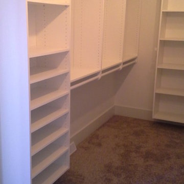 Master closet with shelving and double hang.