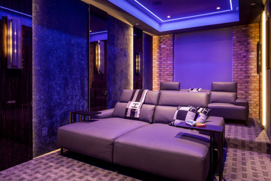 Trendy enclosed carpeted and multicolored floor home theater photo in Tampa with brown walls and a media wall