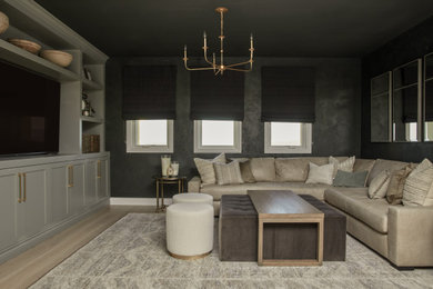 Example of a large trendy loft-style light wood floor living room design in Los Angeles with a media wall