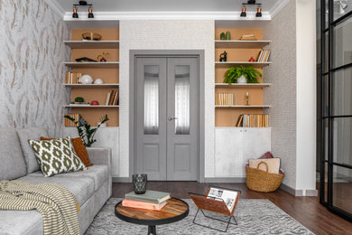На фото: изолированная, объединенная гостиная комната в белых тонах с отделкой деревом в современном стиле с с книжными шкафами и полками, серыми стенами, темным паркетным полом и обоями на стенах с