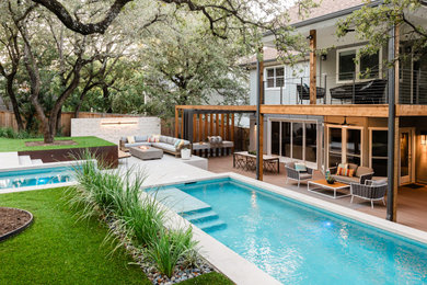 Hot tub - large backyard tile and rectangular lap hot tub idea in Austin