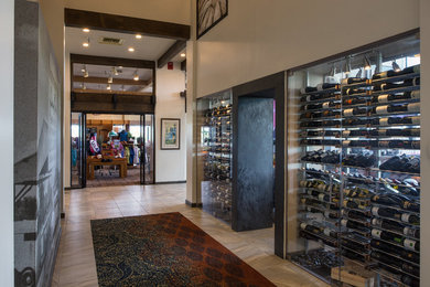 Design ideas for a mid-sized modern wine cellar in Phoenix with porcelain floors and storage racks.