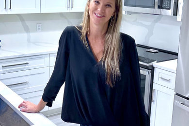 Example of a mid-sized beach style laminate floor and white floor kitchen design in Other with an undermount sink, shaker cabinets, white cabinets, quartz countertops, white backsplash, quartz backsplash, stainless steel appliances and white countertops