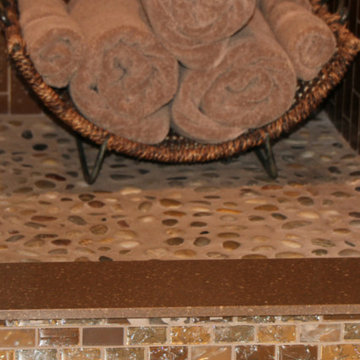 River rock shower floor with crackled glass tiles for outside curb