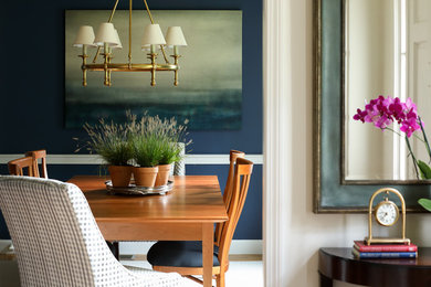 Transitional dining room in Boston with blue walls.