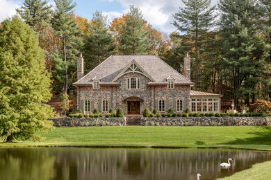 Inspiration for a timeless stone exterior home remodel in Philadelphia with a hip roof