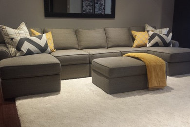 Mid-sized transitional open concept medium tone wood floor and brown floor family room photo in Other with gray walls
