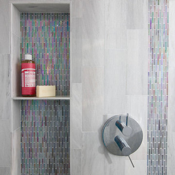 Multi-color glass tile in modern porcelain shower.