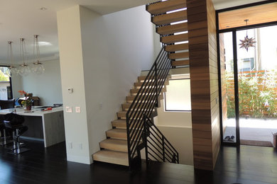 Photo of a large modern wood floating staircase in San Francisco with wood risers.