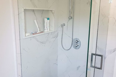 Small minimalist 3/4 white tile and marble tile marble floor and white floor corner shower photo in Toronto with gray walls and a hinged shower door