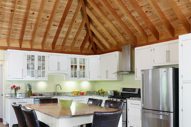 Inspiration for an eclectic kitchen in DC Metro with a farmhouse sink, shaker cabinets, white cabinets, granite benchtops, white splashback, stainless steel appliances, ceramic floors and no island.