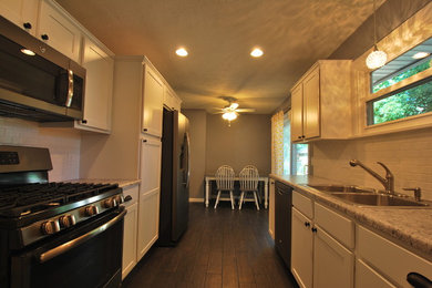Eat-in kitchen - small traditional galley porcelain tile eat-in kitchen idea in Chicago with a double-bowl sink, white cabinets, white backsplash, no island, flat-panel cabinets, subway tile backsplash and laminate countertops