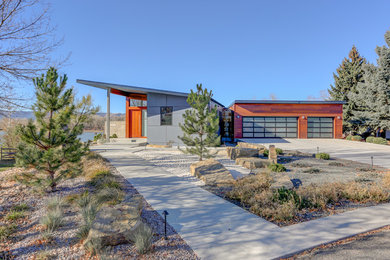 Inspiration for a mid-sized contemporary multicolored two-story mixed siding exterior home remodel in Denver with a shed roof