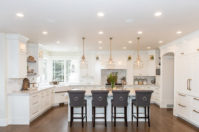 Photo of a country eat-in kitchen in Salt Lake City with a farmhouse sink, shaker cabinets, white cabinets, panelled appliances and with island.