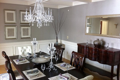 Example of a large transitional medium tone wood floor enclosed dining room design in New York with no fireplace