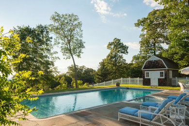 Example of a mid-sized arts and crafts backyard stone and rectangular lap pool house design in New York