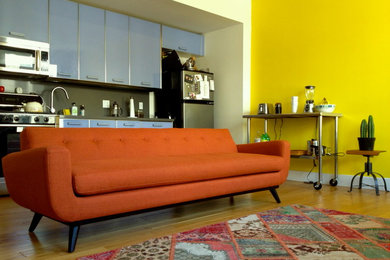 Mid-sized 1950s loft-style bamboo floor and brown floor living room photo in Other with yellow walls and no fireplace