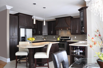 Open concept kitchen - large transitional u-shaped ceramic tile open concept kitchen idea in Ottawa with an undermount sink, shaker cabinets, dark wood cabinets, granite countertops, beige backsplash, glass tile backsplash, stainless steel appliances and an island