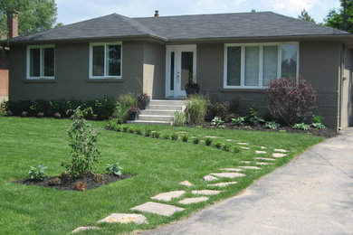 Example of a mid-sized classic beige one-story wood house exterior design in Toronto with a hip roof and a shingle roof
