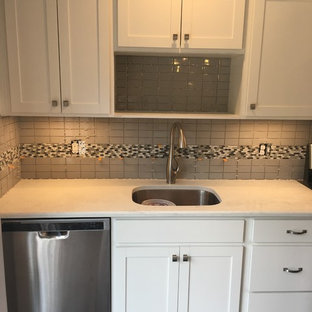 Small modern kitchen pantry photos - Kitchen pantry - small modern dark wood floor and brown floor kitchen pantry idea in Wilmington with an undermount sink, shaker cabinets, white cabinets, quartz countertops, gray backsplash, ceramic backsplash, stainless steel appliances and an island