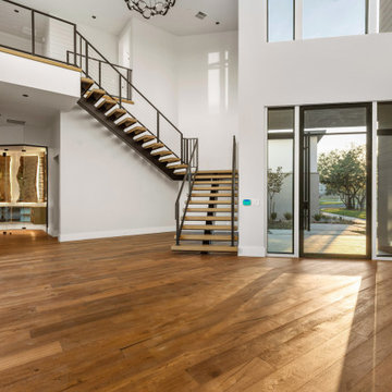 Modern Floating Staircase with Contemporary Metal Railing and Warm Wood Finishes
