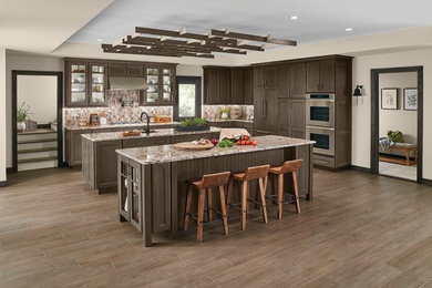 This is an example of a large modern l-shaped kitchen in Other with shaker cabinets, grey cabinets, marble benchtops, stainless steel appliances, multiple islands and grey floor.