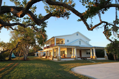 Photo of a large traditional two-storey white house exterior in Orlando with wood siding and a gable roof.