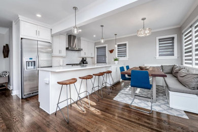 Small transitional galley dark wood floor and brown floor eat-in kitchen photo in Denver with an undermount sink, shaker cabinets, white cabinets, quartz countertops, white backsplash, ceramic backsplash, stainless steel appliances, a peninsula and white countertops