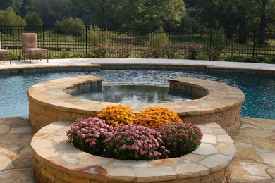 Example of a mid-sized backyard concrete paver and custom-shaped natural hot tub design in Atlanta