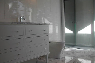 Mid-sized trendy kids' white tile and ceramic tile marble floor bathroom photo in Calgary with furniture-like cabinets, white cabinets, a one-piece toilet, gray walls, an undermount sink and marble countertops