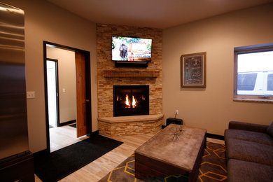 Inspiration for a small transitional enclosed porcelain tile and beige floor living room remodel in Other with beige walls, a corner fireplace, a stone fireplace and a wall-mounted tv