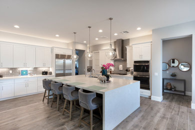 Inspiration for a large modern l-shaped kitchen remodel in Phoenix with shaker cabinets, white cabinets and an island