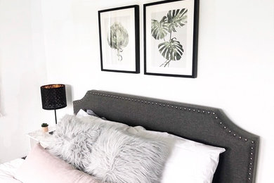 Inspiration for a mid-sized scandinavian guest porcelain tile and brown floor bedroom remodel in Tampa with white walls and no fireplace
