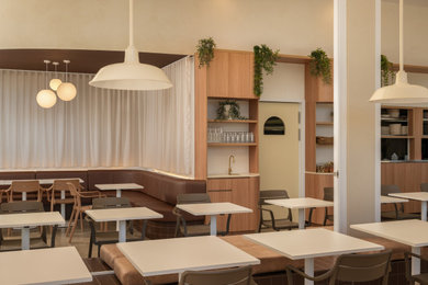 Example of a mid-sized concrete floor and gray floor kitchen/dining room combo design in Sunshine Coast with beige walls