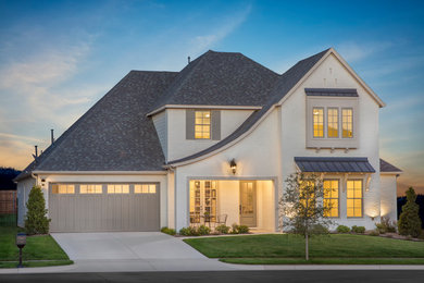 Large transitional beige two-story brick exterior home photo in Dallas with a shingle roof