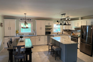 Example of a large transitional l-shaped eat-in kitchen design in Charleston with shaker cabinets, granite countertops, subway tile backsplash and an island