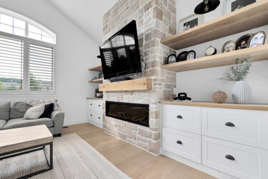 Family room - family room idea in Toronto with a standard fireplace and a stacked stone fireplace